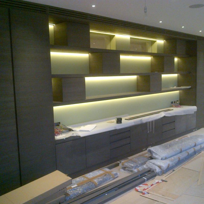 Custom built wall shelving and cupboard units